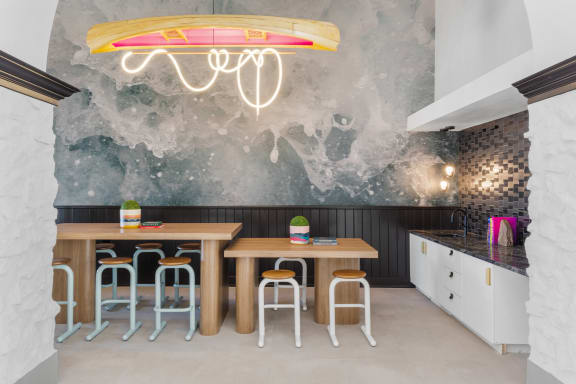 a dining room with a table and chairs and a mural on the wall at Terracina, Broomfield, CO