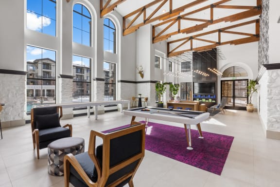 a living room with a pool table and large windows at Terracina, Broomfield, CO 80020