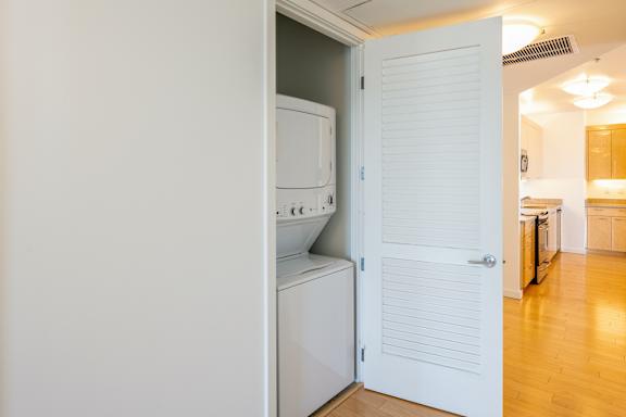 A white door is open to a kitchen at The Grand Apartments, Oakland, CA, 94612