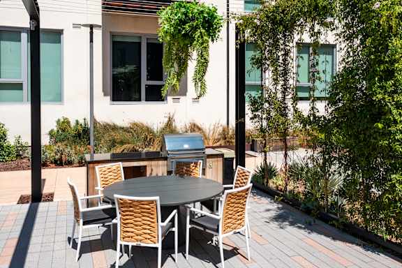 A table with chairs is set up outside on a patio.