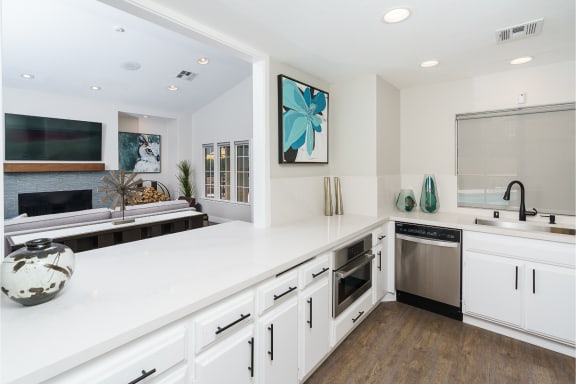 a white kitchen with a large counter top and a sink at Westlake Canyon, California