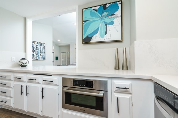 a kitchen with white cabinets and a painting on the wall at Westlake Canyon, California 91362