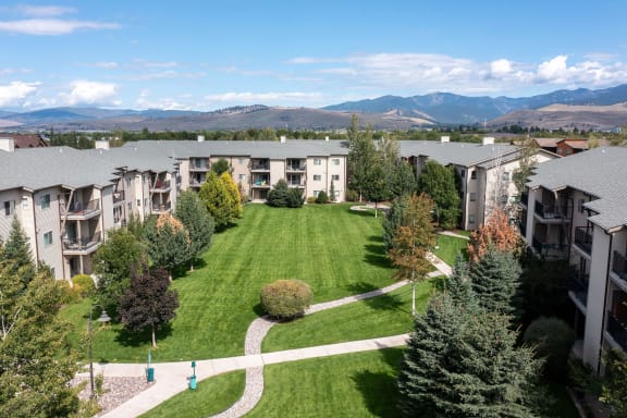an aerial view of an apartment complex with a lawn and treesMullan Reserve Apartments, Missoula, MT 59808