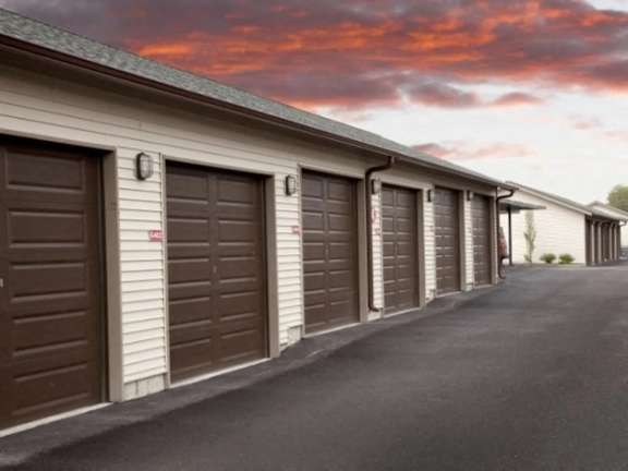 Row of private garages with exterior lighting at Mullan Reserve Apartments, Montana, 59808