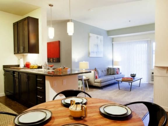 a kitchen and living room with a wooden table and chairs at Mullan Reserve Apartments, Missoula, MT