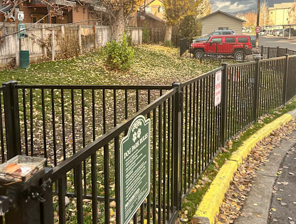 Fenced dog park area with autumn ground cover at Mullan Reserve Apartments, Missoula, MT