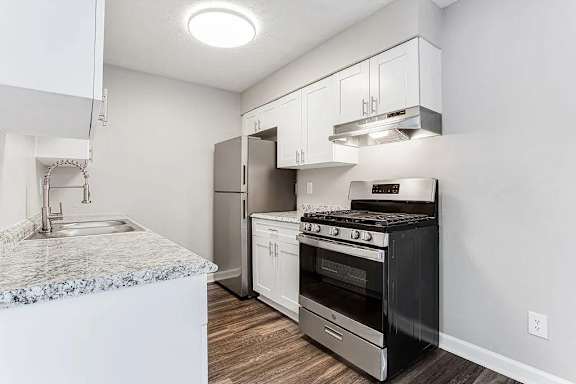 A modern kitchen with a black stove top oven.
