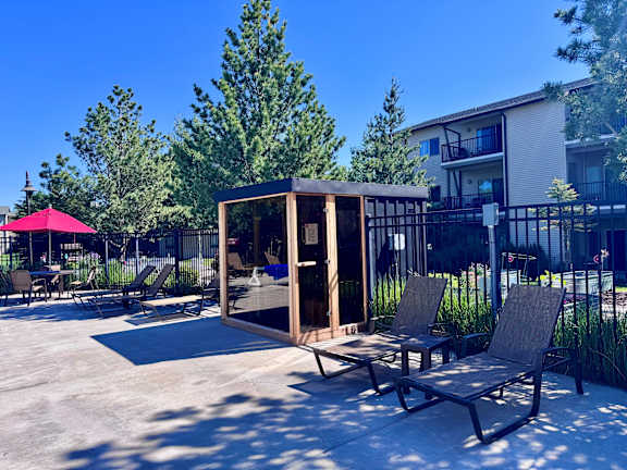 A sunny day at the outdoor patio with chairs and a table.