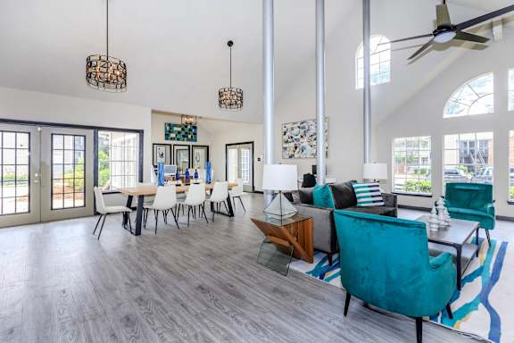 a living room and dining room with a table and chairs