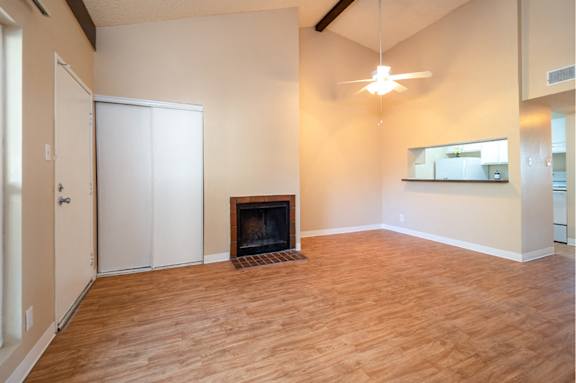 A room with a fireplace and a mirror on the wall.