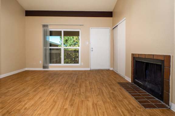 A room with a fireplace and a sliding glass door.