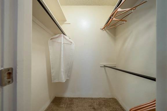 A white door with a white coat hanging on a hook.