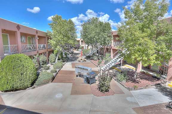 A sunny day at the apartment complex with a clear blue sky.