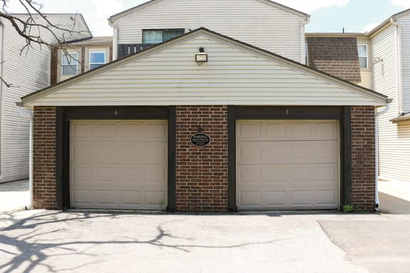 two garage doors on the side of a house