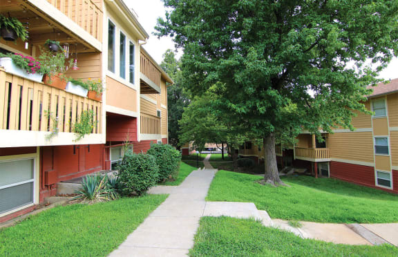 a sidewalk between two apartment buildings