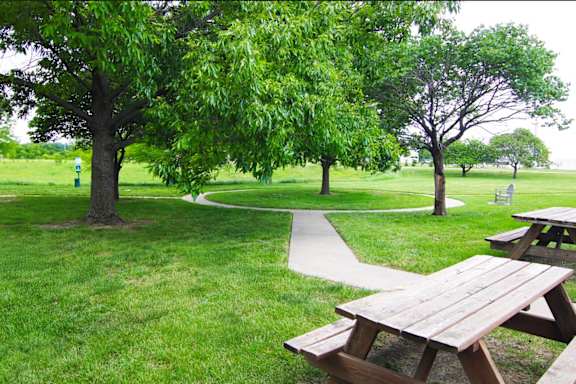 Park with picnic table at Cottages of Topeka, Topeka