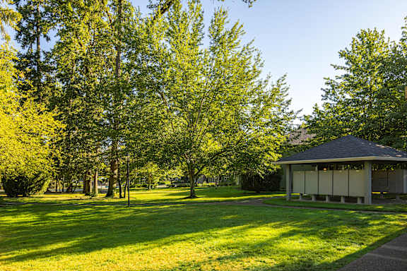 A gazebo sits in the middle of a grassy field.