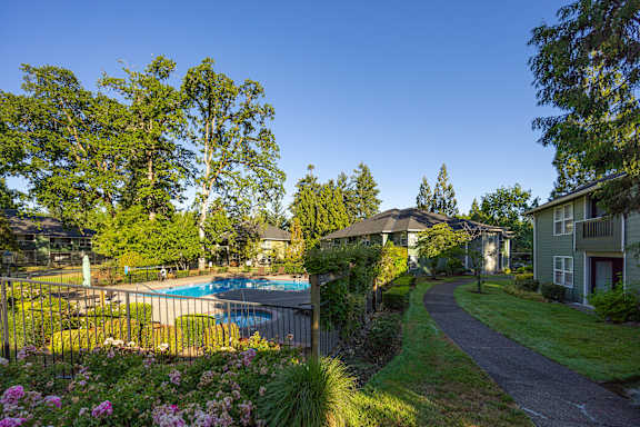 A residential area with houses, a pool, and a statue.