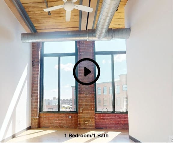 a room with a large window and a ceiling fan     and a