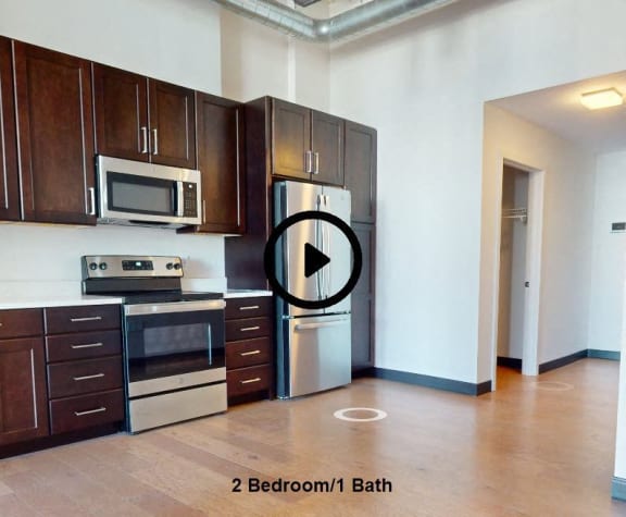 an empty kitchen with a stove and a refrigerator