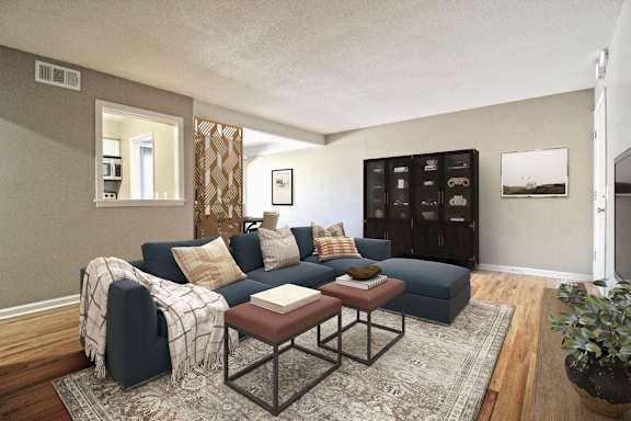 A living room with a dark blue couch and a coffee table.