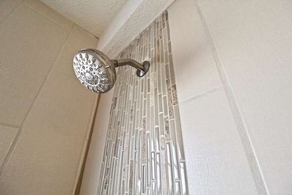 A shower head mounted on a wall.