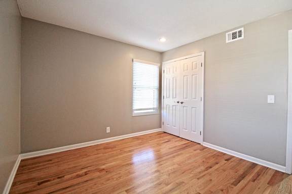 A room with a wooden floor and a white door.