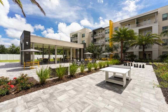 a white bench sitting in front of a building  at Fusion, Jacksonville, 32256