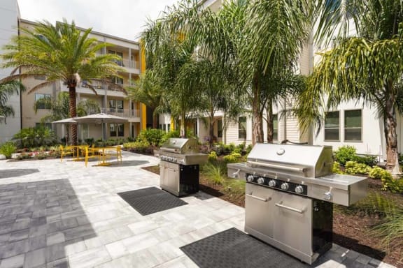 two grills in a courtyard with a building in the background  at Fusion, Florida, 32256