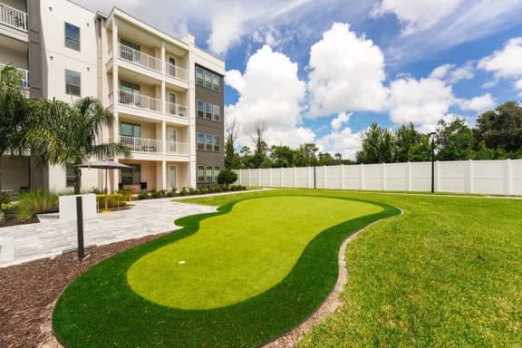 a grassy area in front of an apartment building  at Fusion, Jacksonville, FL, 32256