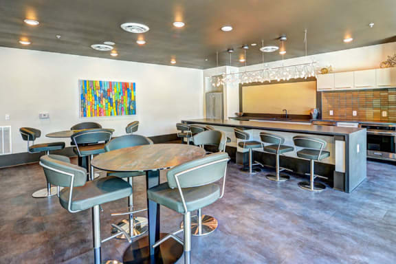 a room with a long table and chairs and a kitchen in the background  at Fusion, Jacksonville, 32256
