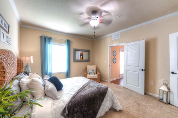 a bedroom with a bed and a ceiling fan  at Cabana Club - Galleria Club, Florida, 32256