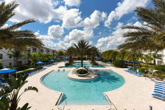 a large pool with a fountain in the middle of it  at Palm Bay Club, Jacksonville, FL