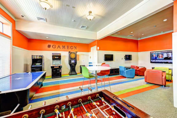 a game room with a foosball table and a ping pong table  at Hacienda Club, Jacksonville, 32256