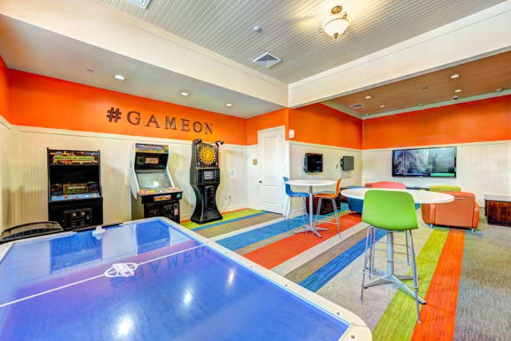 a game room with a ping pong table and arcade games  at Hacienda Club, Jacksonville, Florida