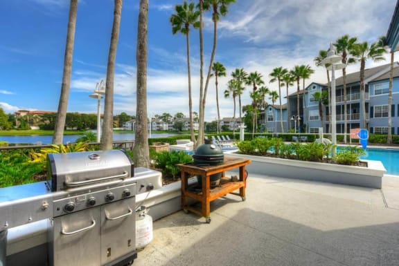 a barbecue grill sitting next to a table with a kettle on it  at Ocean Park, Jacksonville Beach, FL