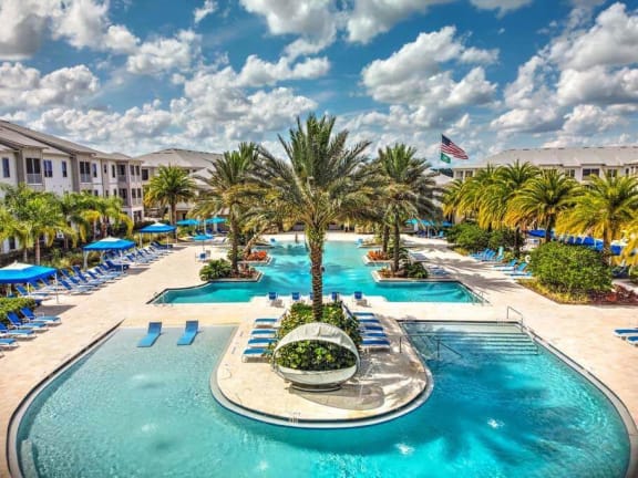 a large swimming pool with a fountain in the middle of it  at Palm Bay Club, Jacksonville, FL