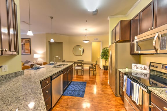 Kitchen with Granite Countertops and Stainless Steel Appliances  at Alaqua, Florida