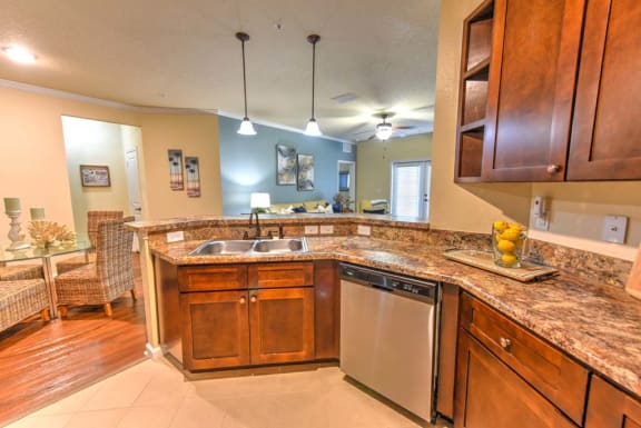 a kitchen with a sink and a dishwasher  at Cabana Club - Galleria Club, Jacksonville, FL
