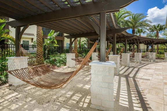 a hammock is sitting in the middle of a patio  at Cabana Club - Galleria Club, Florida, 32256