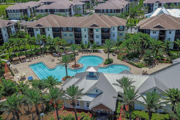 an aerial view of a resort style swimming pool with palm trees  at Cabana Club - Galleria Club, Jacksonville, Florida