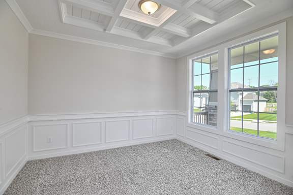 A room with white walls and a carpeted floor.