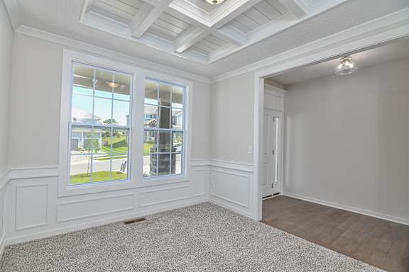A room with a window overlooking a street.