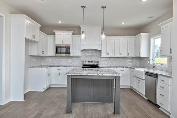 A kitchen with a large island in the middle.