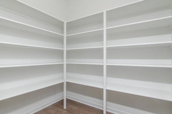 Empty white shelves in a room.