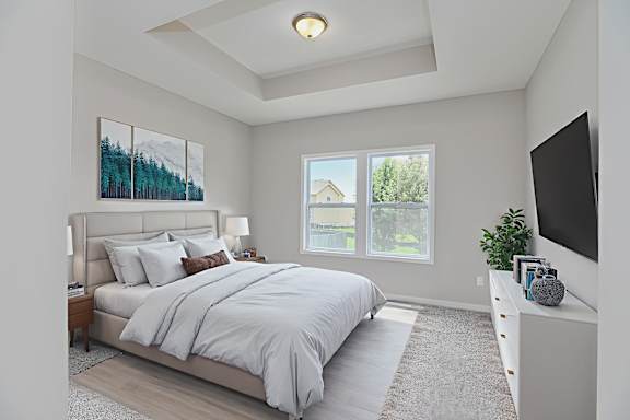 A bedroom with a large bed and a painting on the wall.