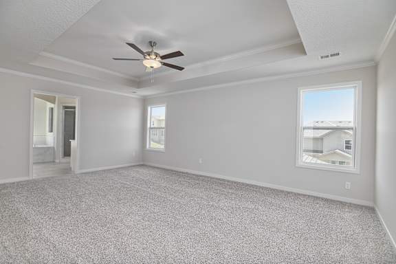 A spacious room with a ceiling fan and a window.