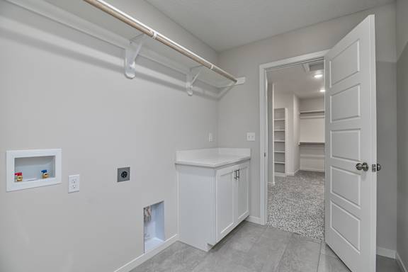A white cabinet with a door is in the room.