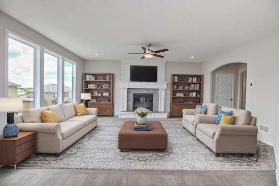 A living room with a fireplace, two couches, and a coffee table.