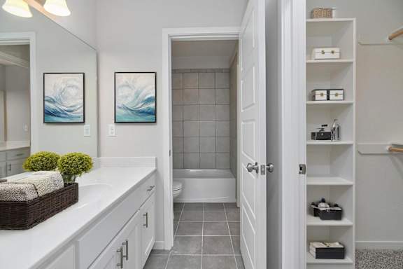 A bathroom with a white countertop and a white door.